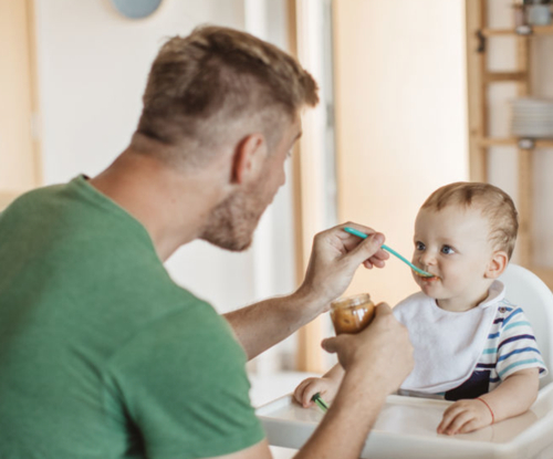 father feeding child